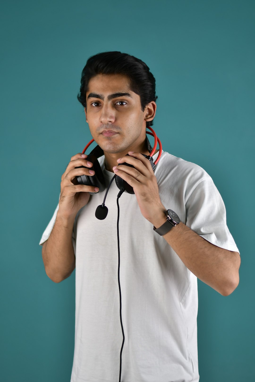 Men holding a headphones.